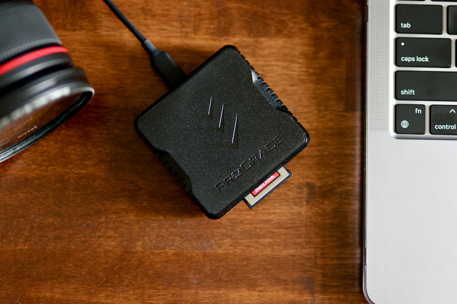 Close-up of SD card inserted into a reader transferring files to an ingest folder