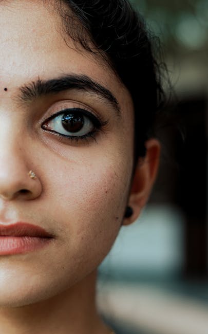 Portrait close-up with visible film-like grain and subtle color speckles in shadows