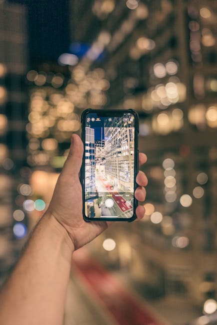 Photographer holding camera during nighttime city shooting with computational low-light effect
