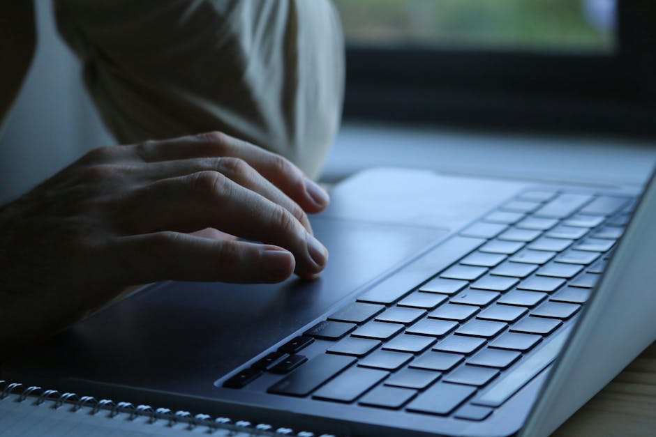 Person reviewing an email on a laptop while protecting accounts from phishing