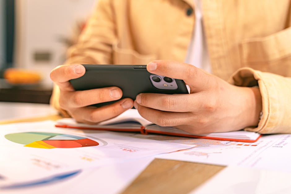 Photographer hovering over an email link on a phone, checking for phishing red flags