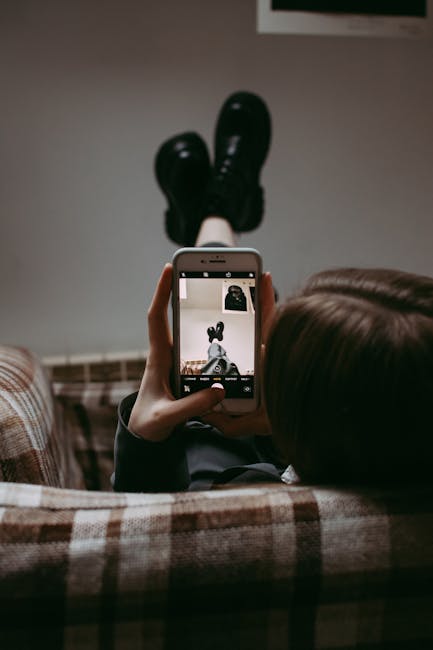 Photographer zooming into a dark gradient on a laptop to inspect JPEG compression artifacts