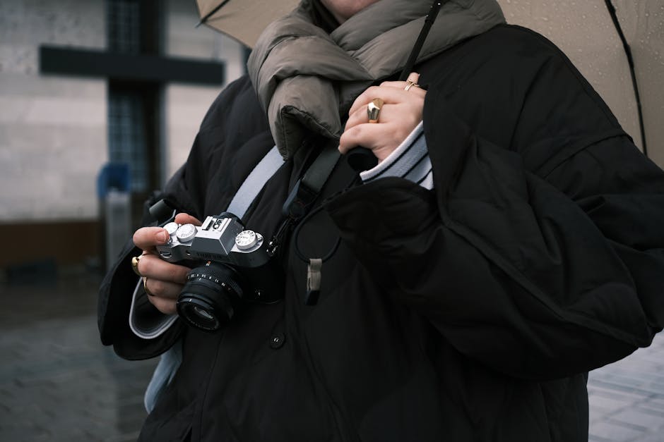 Photographer’s camera under a clear rain cover on a construction site
