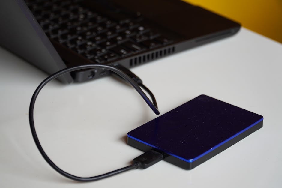 External backup hard drive unplugged from a laptop, representing offline read-only backups