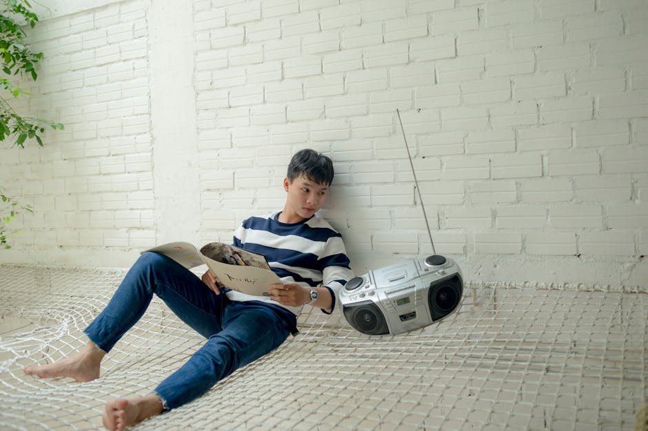 Photographer listening to Lithuanian radio on a laptop while sorting photos.