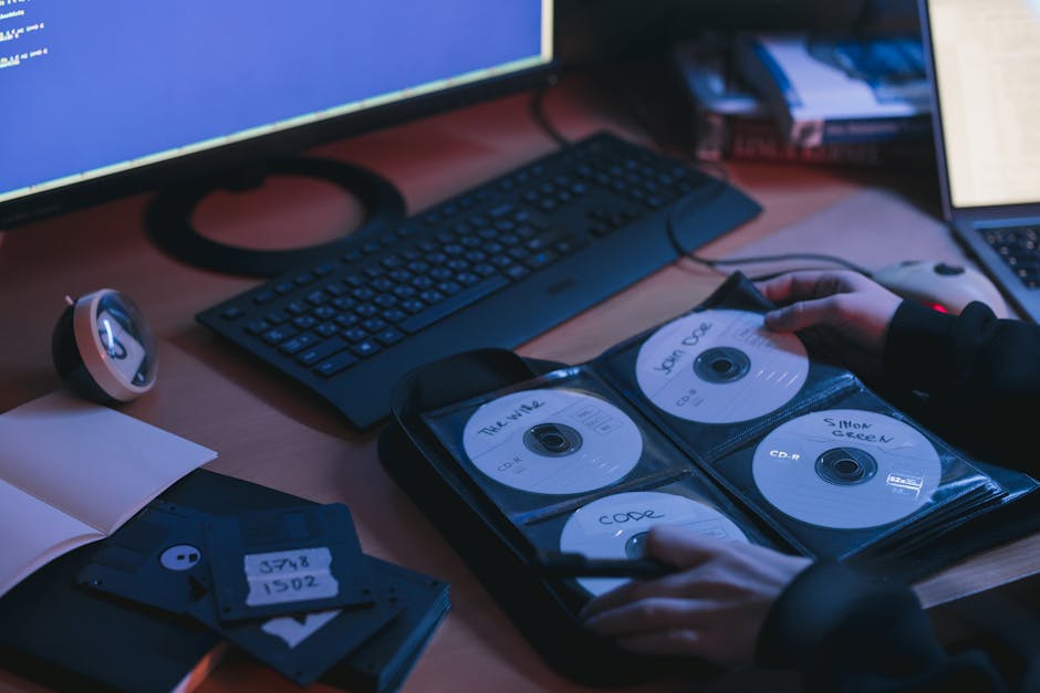 Close-up of a hand using a laptop to access a client download link on a secure page